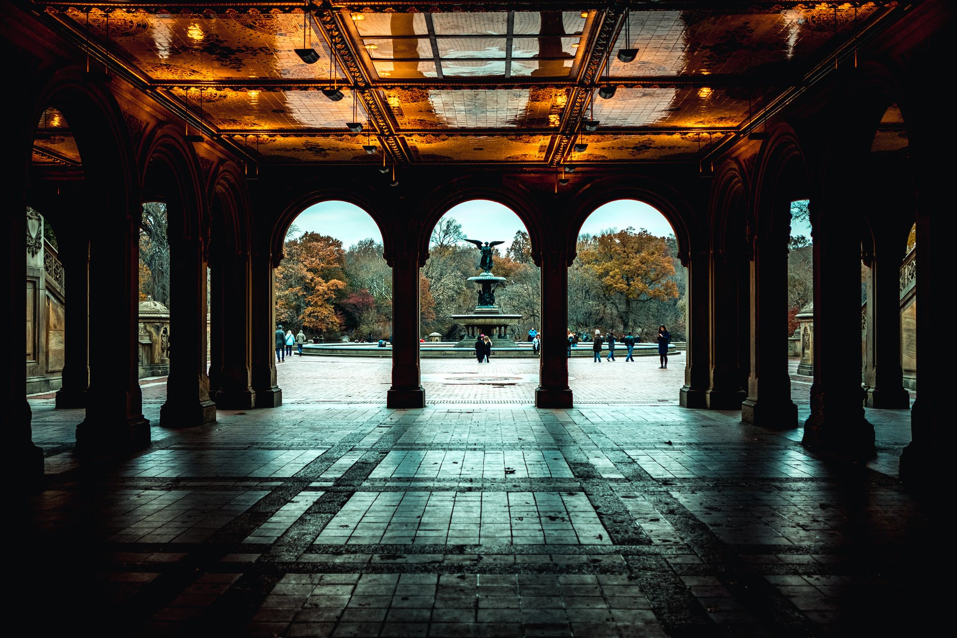 arches and pillars of a building with floor tiles