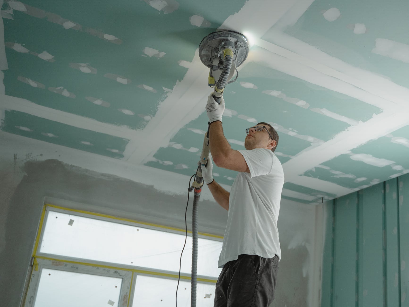 man polishing the ceiling