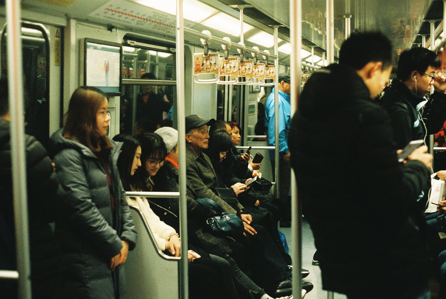 people sitting and standing inside train